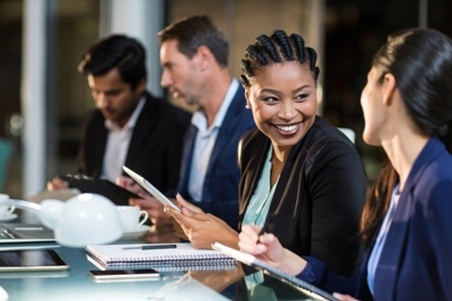 Businesswoman-interacting-with-a-colleague-in-the-office-2 - A Simple and Effective Way To Improve Corporate Communication