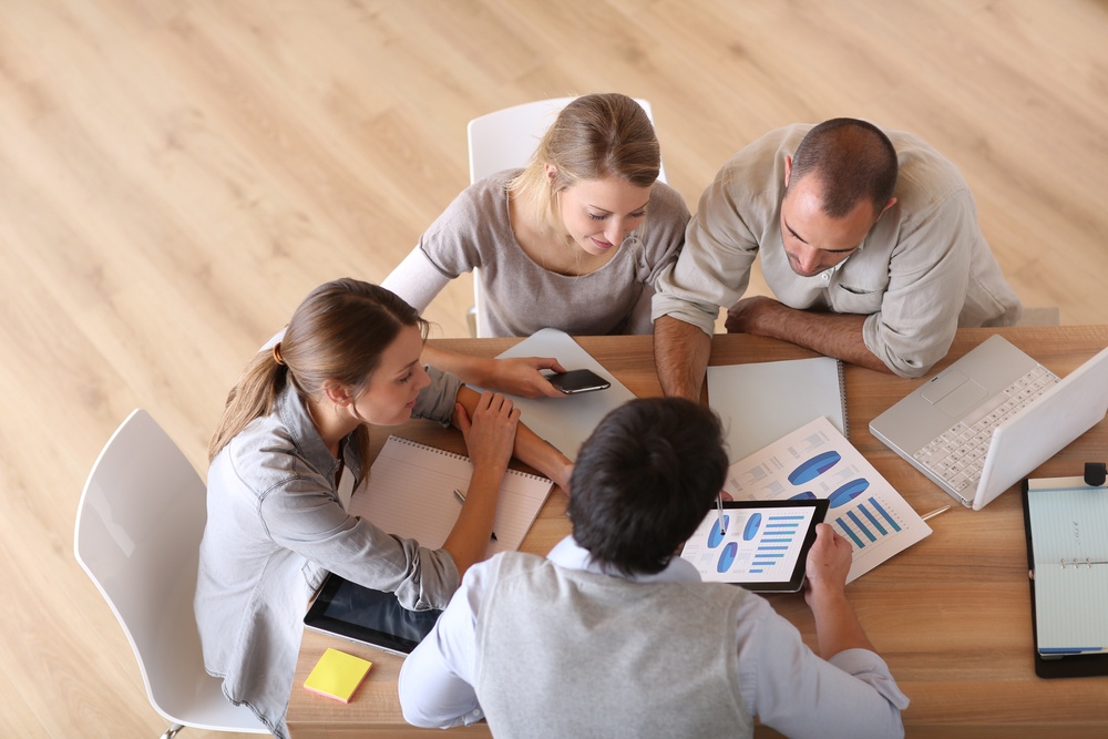 Upper-view-of-business-people-around-table - Don’t Let Change Derail You: Tips To Keep Your Change Initiatives On Track